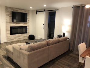 Electric fireplace and 50” Roku TV equipped with Prime video & Hulu live