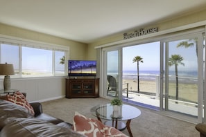 Living room with sofa sleeper and private balcony access