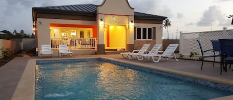 Pool, Pool Deck and front of villa at dusk