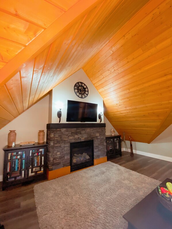 Our hand stained cedar ceilings and cozy fireplace. 