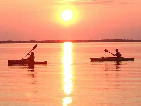 Kayaking at sunset in front of the cottage.