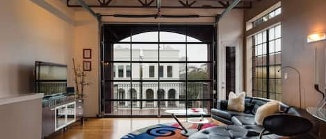 Living room with leather living room set with a huge glass door.