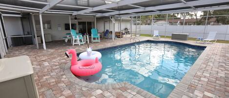 Enjoy the large heated pool, hot tub, grill, and covered patio.