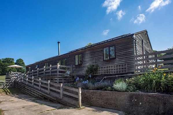 The Barn showing the ramp access, decking area and parking area
