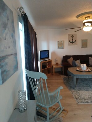 Entrance into the living room area. Wrap around couch for comfy days! 