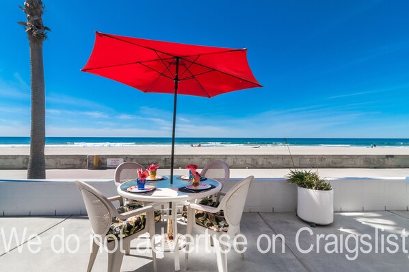 Patio Table right outside the Condo with Beach and Ocean in the Background