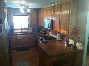 Easy to use kitchen with concrete counter tops.