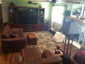 Living area with large flat screen TV, DVD and VHS players.