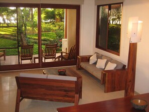 Living area showing the natural light of the end unit and the patio facing ocean