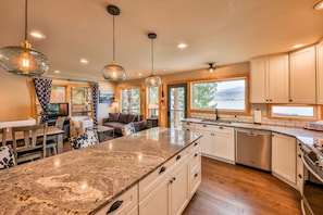 Sparkling  clean kitchen with stainless appliances and granite counters.