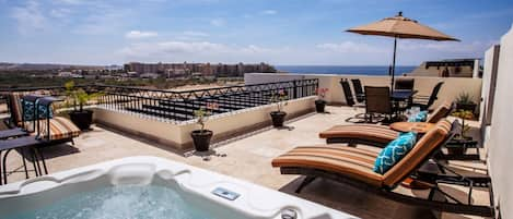 Relax in your jacuzzi on your private rooftop deck viewing the beach.