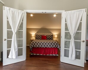 Master bedroom with comfy pillow top queen size bed, cotton sheets, & usb lamps.