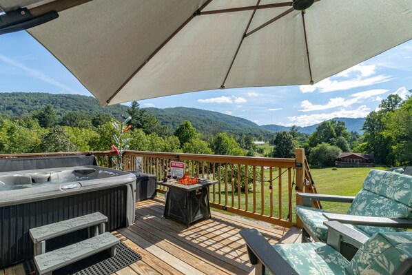 Pop open the umbrella to enjoy beautiful views in the shade on comfy adirondacks