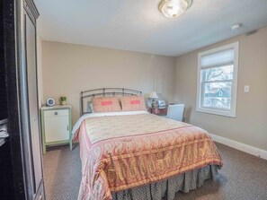 The North Bedroom with queen bed, desk and chair.