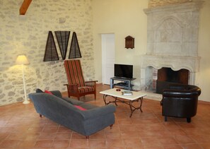 Living room with historic fireplace. Doorway leads to downstairs toilet.