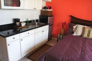 Kitchen with stove, microwave, refrigerator, and all dishes