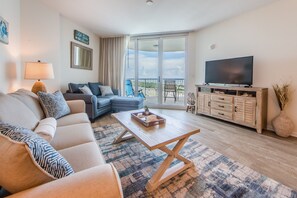 Living Room has flat screen TV and Balcony access