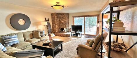 Open floor plan living room with mountain and lake views