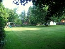 Fenced in back yard with swing set