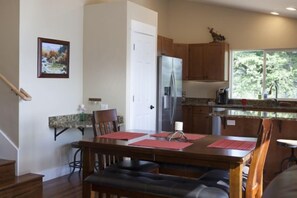 expandable dining table for up to 8 utilizing adjustable height bar stools.