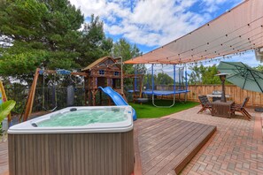 Backyard. Large gas grill. Hot-tub. 10ft Trampoline.  Playhouse  Slide + Swings.
