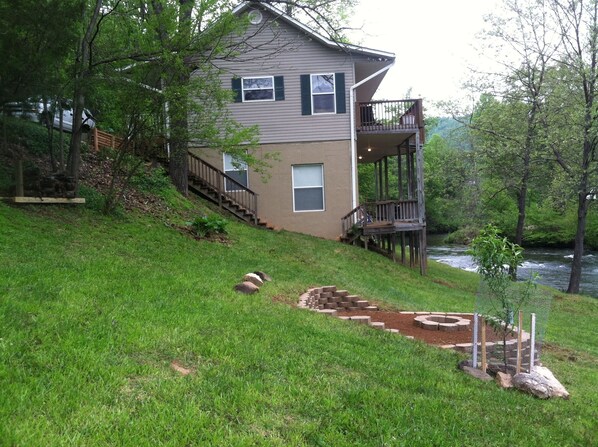 sideview of home, river and fire pit 