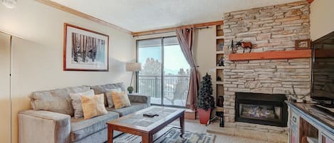 Living area with gas fireplace and balcony