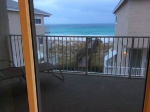 View from King bedrm.  Two chaise lounge chairs and small table are on balcony.