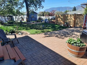 Fully fenced shared backyard and covered outdoor patio area.