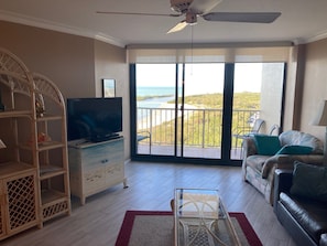 Living area with patio doors that lead to the outdoor balcony.