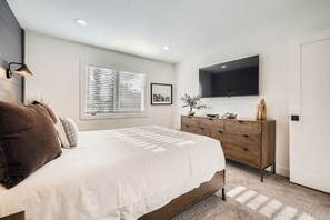 nwind in the serene main bedroom, featuring soft linens, calming decor, and a cozy atmosphere—your private retreat for restful nights and peaceful mornings.