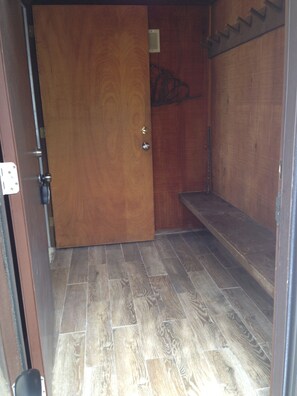 Entry/mudroom with glass storm door to let the outside in.