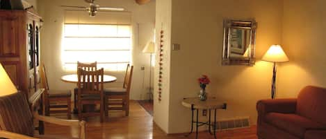 Living room view toward dining room with hand peeled "Viga" ceiling beams