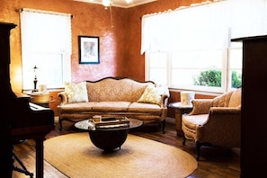 The living room is outfitted with antique reproductions as well as antiques.