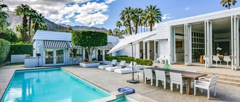 Rear yard with loungers, umbrellas and Dining for 8.