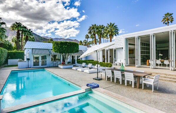 Rear yard with loungers, umbrellas and Dining for 8.