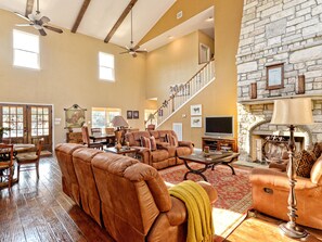 Great living room with large gas fireplace and large dining table.
