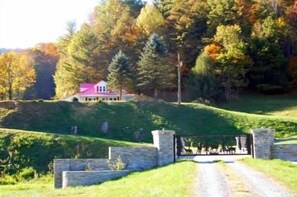 Gated entrance to private 27 acre farm and a view of the Red Roof Farmhouse.