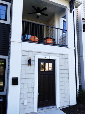 The front entryway with a relaxing porch above.