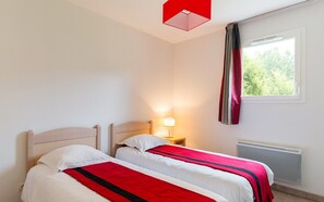 The first bedroom has 2 single beds.