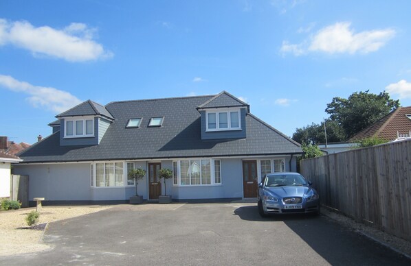 The flat is on the right hand side of the property, behind Car. Self Check-In.