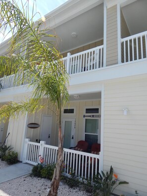 The front entry way. Top floor balcony with lower level private patio