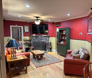 living room with Adirondack theme, 65 in smart tv, Adirondack stone fireplace