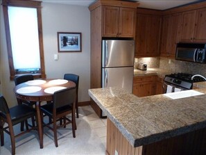 Kitchen with stainless and granite.  Fully stocked with pots, plates and silver.