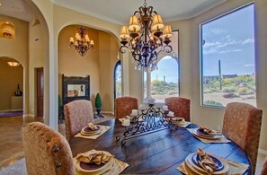 Formal Dining room with large view windows of the desert landscape.