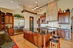 Chef gourmet kitchen, commercial appliances, granite large island counter. 