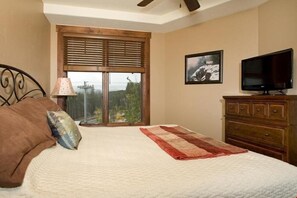 The bedrooms feature large windows with beautiful views
