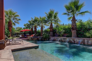 Large oasis pool with waterfall features for ultimate relaxation.