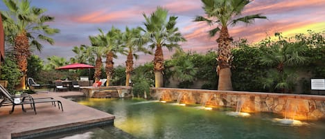 Large oasis pool with waterfall features for ultimate relaxation.