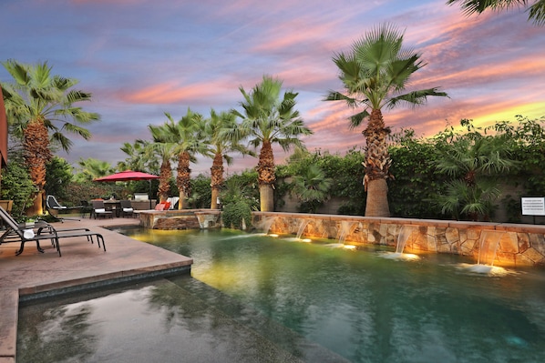 Large oasis pool with waterfall features for ultimate relaxation.